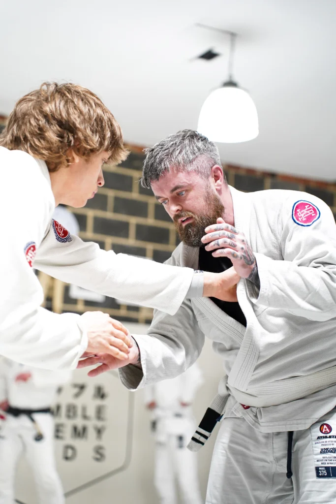 Two training partners practising Gi Brazilian Jiu-Jitsu at Scramble Academy Leeds